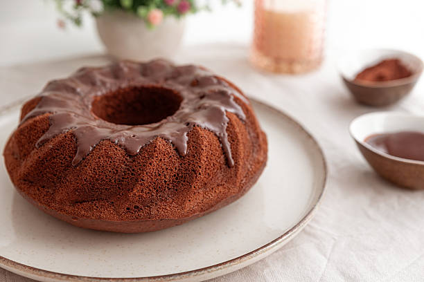istock Chocolate cake with chocolate icing on white wooden table. 2232976593