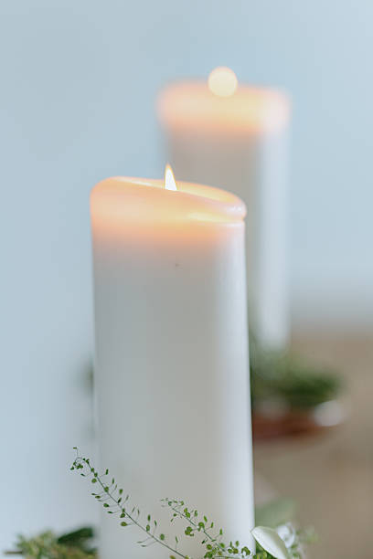 istock Softly Glowing White Candles with Greenery 2232976960