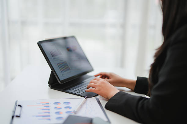 istock Businesswoman working with financial data on a digital tablet, analyzing charts and graphs for investment strategy 2232978517