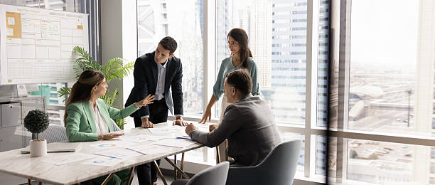 istock Panoramic image of four professional negotiating in modern conference room 2232978938