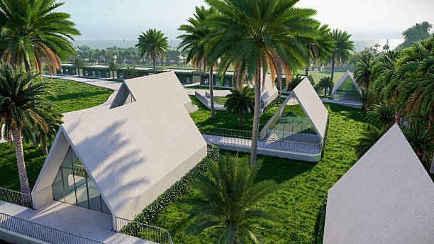 A contemporary architectural design showcasing a triangular-shaped house amidst lush green surroundings and palm trees, evoking feelings of relaxation and tropical luxury.