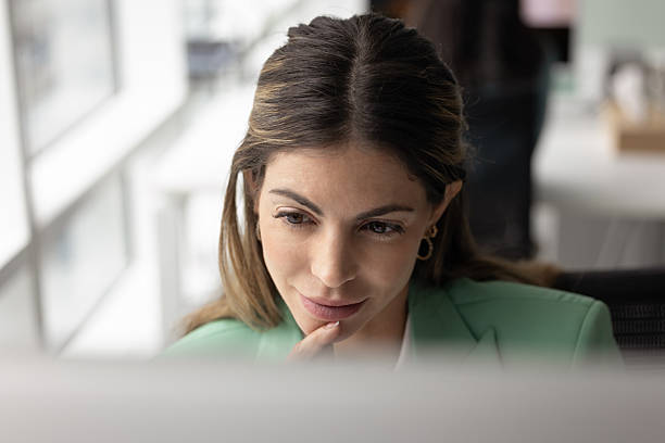 istock Close up of woman deeply focused on computer screen 2232979907
