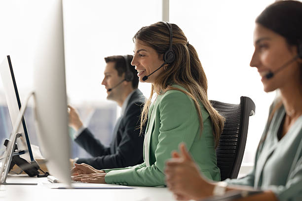 istock Group of customer service representatives sit at modern office workstation 2232981598