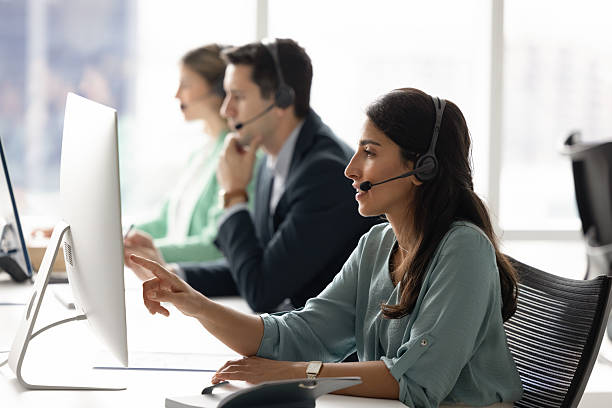 istock Focused woman wear headset providing support or assistance to client 2232981671