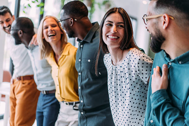 istock Excited coworkers embracing each other during a celebration in the office. 2232984194