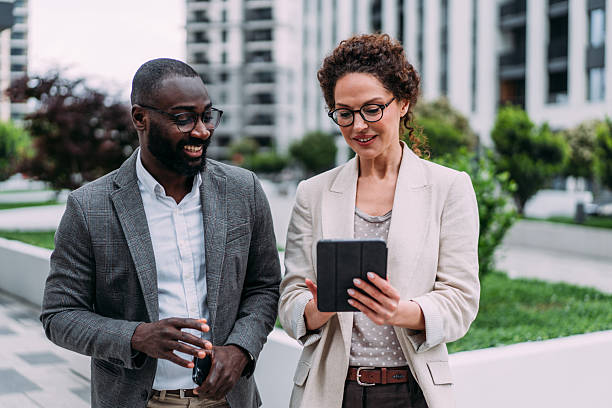 istock Business people using digital tablet outdoors. 2232984230