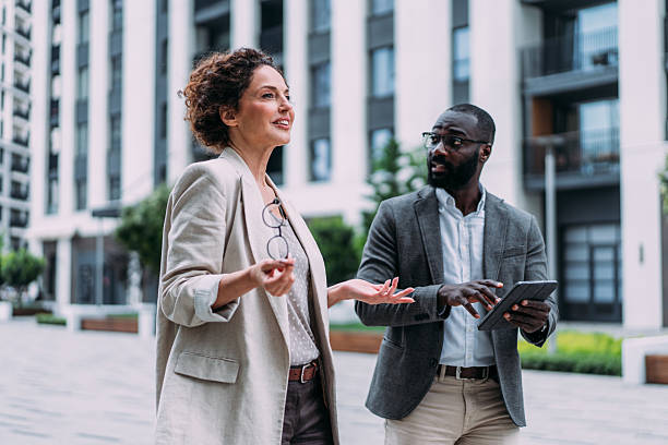 istock Business people using digital tablet outdoors. 2232984231