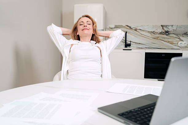 istock Relaxed woman enjoying her work from home setup in a modern apartment 2232986025