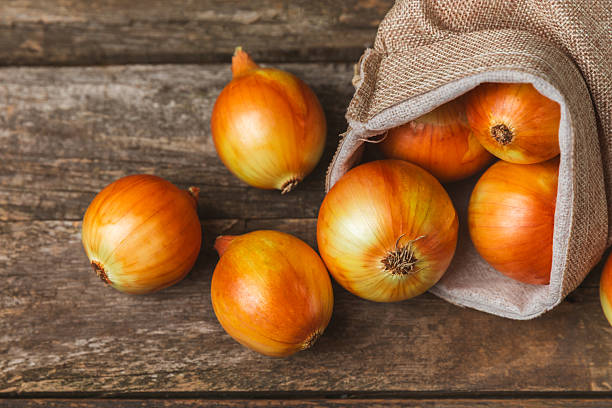 istock Onion on the kitchen table. onion slice. onion rings. Fresh Yellow Onion. Natural, fresh, vegetarian food. Agricultural products. Healthy eating. Vegetables. Farmer's market. Space for text.Copy space 2232987601