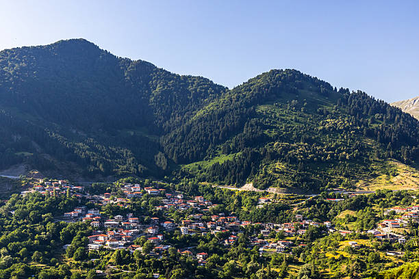 Metsovo, Greece – 1 July 2025: A panoramic mountain landscape as seen from the town of Metsovo in Epirus, Northern Greece. The view overlooks nearby villages nestled on the green slopes of the Pindus mountains, with dense forests and alpine scenery dominating the horizon. The region is known for its natural beauty, traditional architecture, and cultural heritage, making Metsovo a gateway to the highlands of Epirus and the Pindus range.