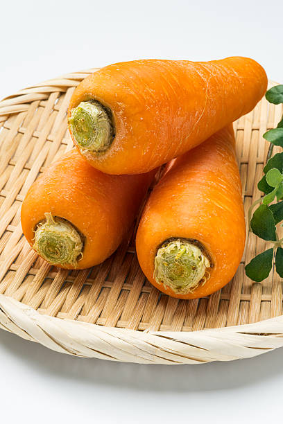 Fresh carrots on a bamboo tray