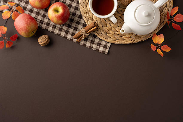 istock Rustic autumn setup featuring apples, tea, and leaves on a dark rustic table 2232991923
