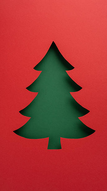 istock Festive vertical template and elegant Christmas greeting card design with a tree cutout against vibrant colors 2232991971