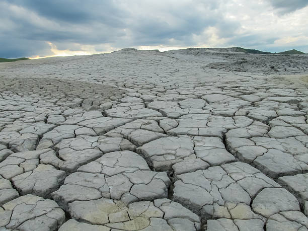 istock Mud volcano landscape in Buzau, Romania. Grey dried mud with surface cracks, arid textures 2232993920