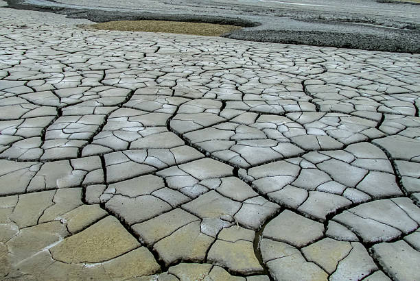 istock Mud volcano landscape in Buzau, Romania. Grey dried mud with surface cracks, arid textures 2232993929
