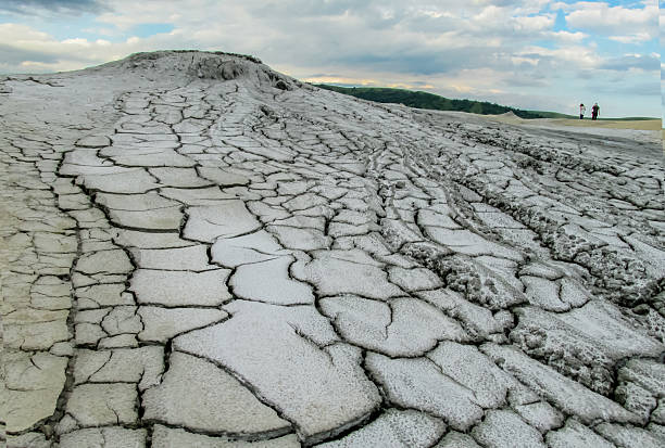istock Mud volcano landscape in Buzau, Romania. Grey dried mud with surface cracks, arid textures 2232993944