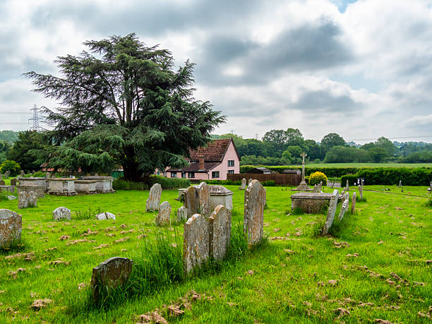 Part of the graveyard outside St Mary’s church in the small village of Earl Stonham in Suffolk, Eastern England, on a cloudy day in springtime.