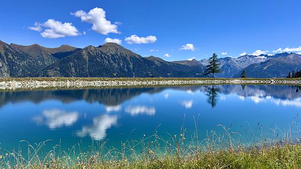 istock Stunning alpine landscape with a clear lake and reflective mountains during midday 2232995756