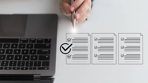 istock Businesswoman using a laptop and pen with digital checklist documents, concept of task management, productivity, project planning, and business organization. 2232999942
