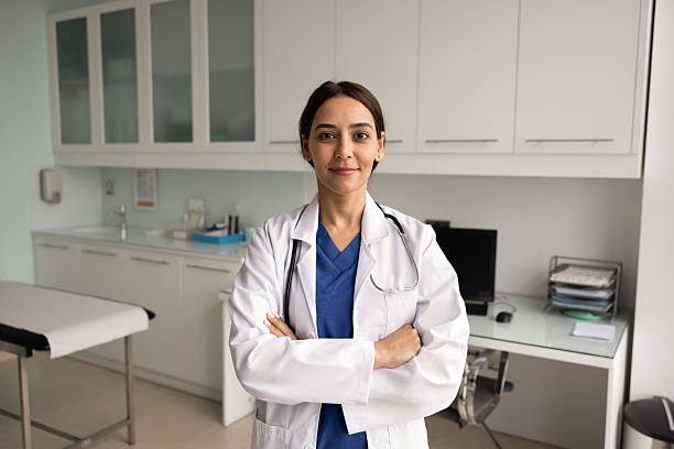 istock Positive confident young Middle Eastern physician woman wearing lab coat 2233001145