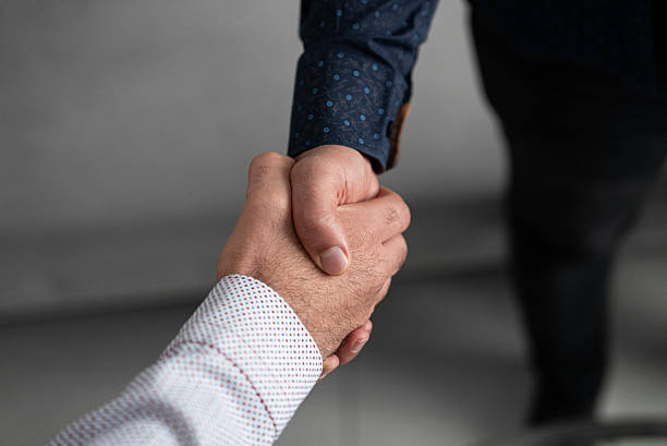 istock Business handshake partnership agreement close-up 2233002717