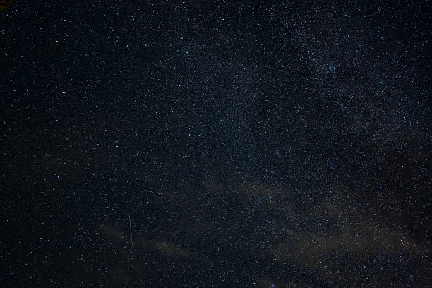 istock Clear Night Sky with Stars, Meteor Streak, and Thin Clouds 2233007868