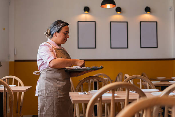 istock Restaurant owner gets ready to open the doors and start serving customers 2233009173