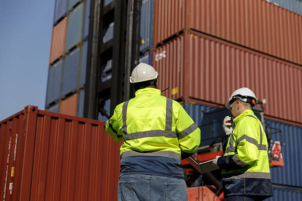 istock Engineers inspect goods and containers for export by global businesses. 2233010385