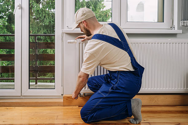 istock Professional plumber performing maintenance on a home radiator heating system 2233015880