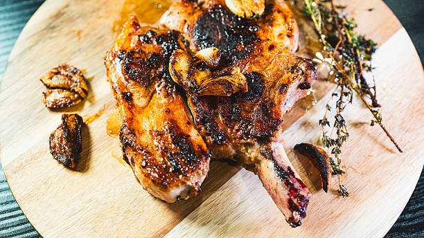 istock Grilled pork chop on wooden board 2233019521