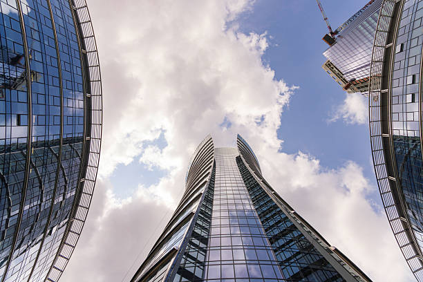 istock Modern glass skyscrapers reflecting the cloudy sky from a low angle view 2233019599