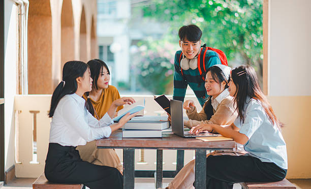 istock group of students young university students consulting doing homework, cooperating research plan Discuss concepts and strategies. Prepare presentations on laptops and tablet computers. 2233020706