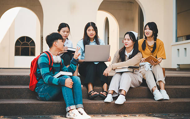 istock group of students young university students consulting doing homework, cooperating research plan Discuss concepts and strategies. Prepare presentations on laptops and tablet computers. 2233020767