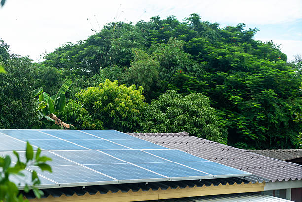 istock Solar Panels on Roof With Green Trees 2233030153