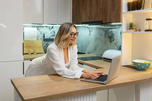 istock Freelance woman working on laptop in modern 2233030638