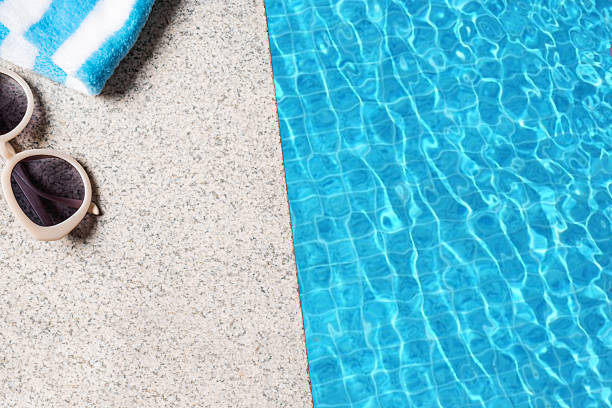 istock Edge of pool with towel and sunglasses 2233030683