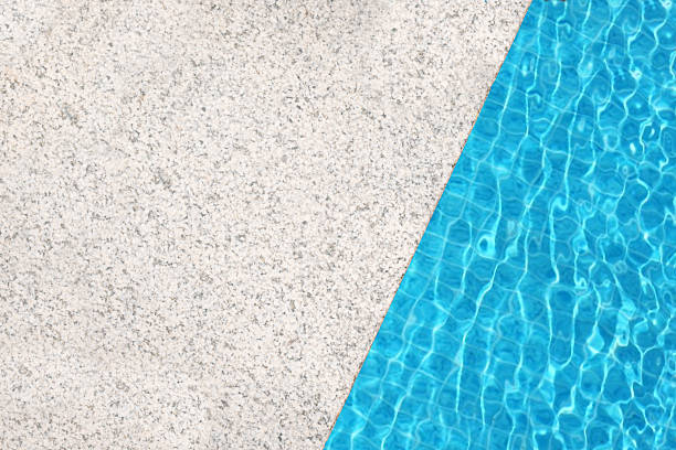 White stone edge of pool and blue pool water texture. Top view, copy space, design template.