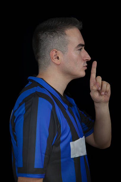 To be quiet, silence gesture on black backround.
