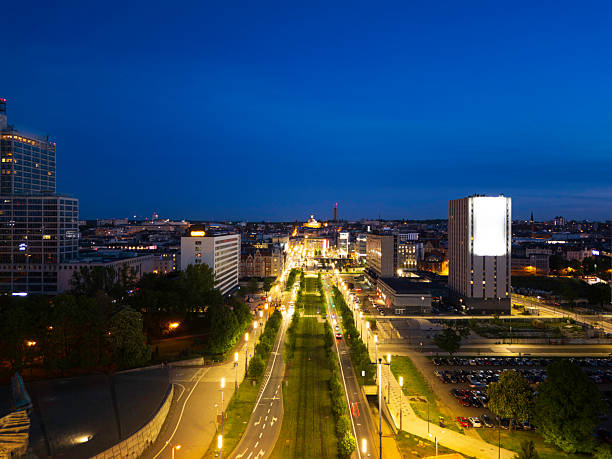 istock Nighttime cityscape view with illuminated buildings and clear blue sky 2233034839
