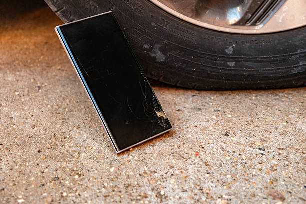 A phone that just fell to the ground with a broken screen. The fall was so great that pieces of the screen blew off revealing the metal of the structure