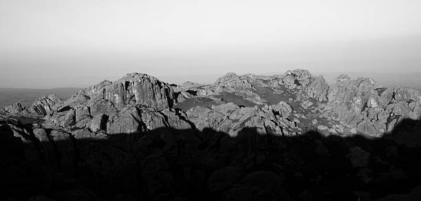 View of the rocky cliffs high in the mountains while the sun sets at nightfall