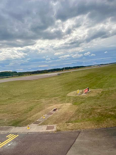 istock Airfield View with Green Grass and Overcast Sky 2233035922