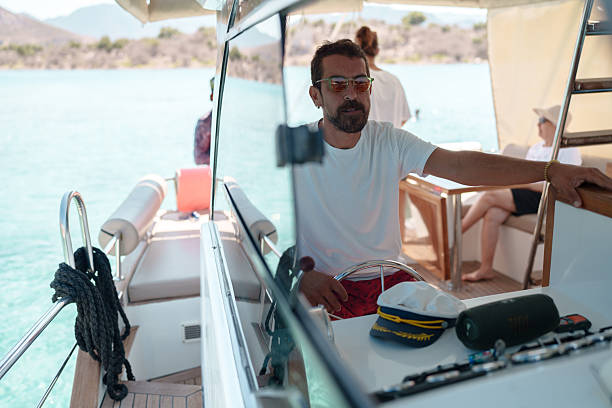 istock Man Steering a Boat on a Sunny Day 2233038330