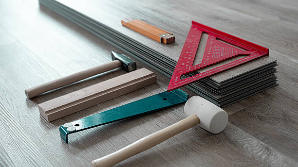 istock Floating floor work. The boards of vinyl plank with necessary tools on the floor. 2233042598