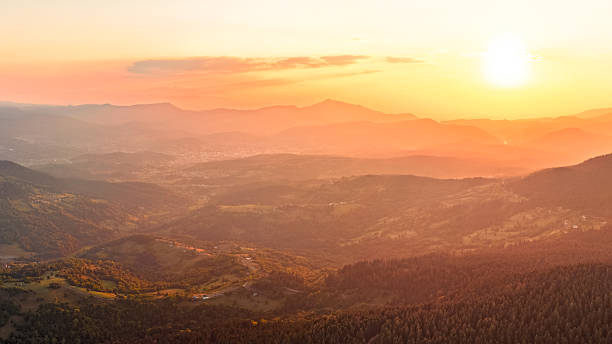 istock Sunset panorama over rolling hills and mountain silhouettes 2233049434