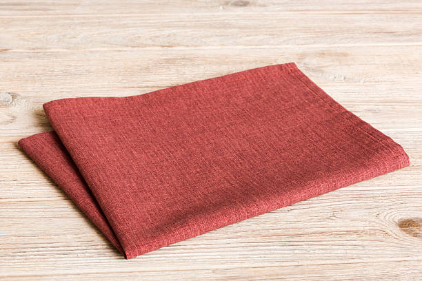 istock top view with red empty kitchen napkin isolated on table background. Folded cloth for mockup with copy space, Flat lay. Minimal style 2233056319