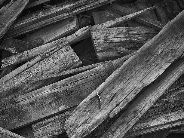 A background of old wooden planks with rusty nails in them. Black and white. Close up.