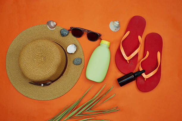 istock Beach Essentials on Orange Background Featuring Hat and Sandals 2233063226