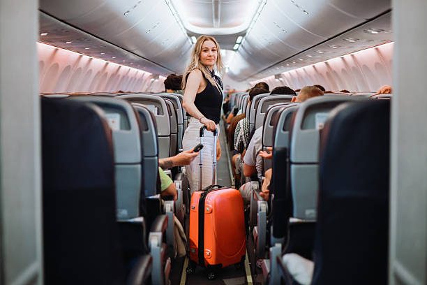 istock Interior of airplane with people sitting on seats 2233067330