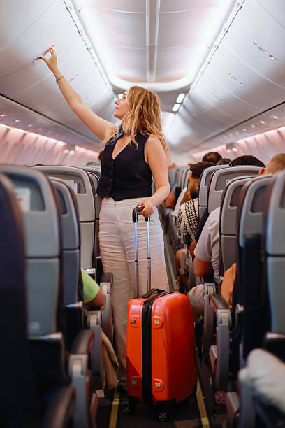istock Interior of airplane with people sitting on seats 2233067359